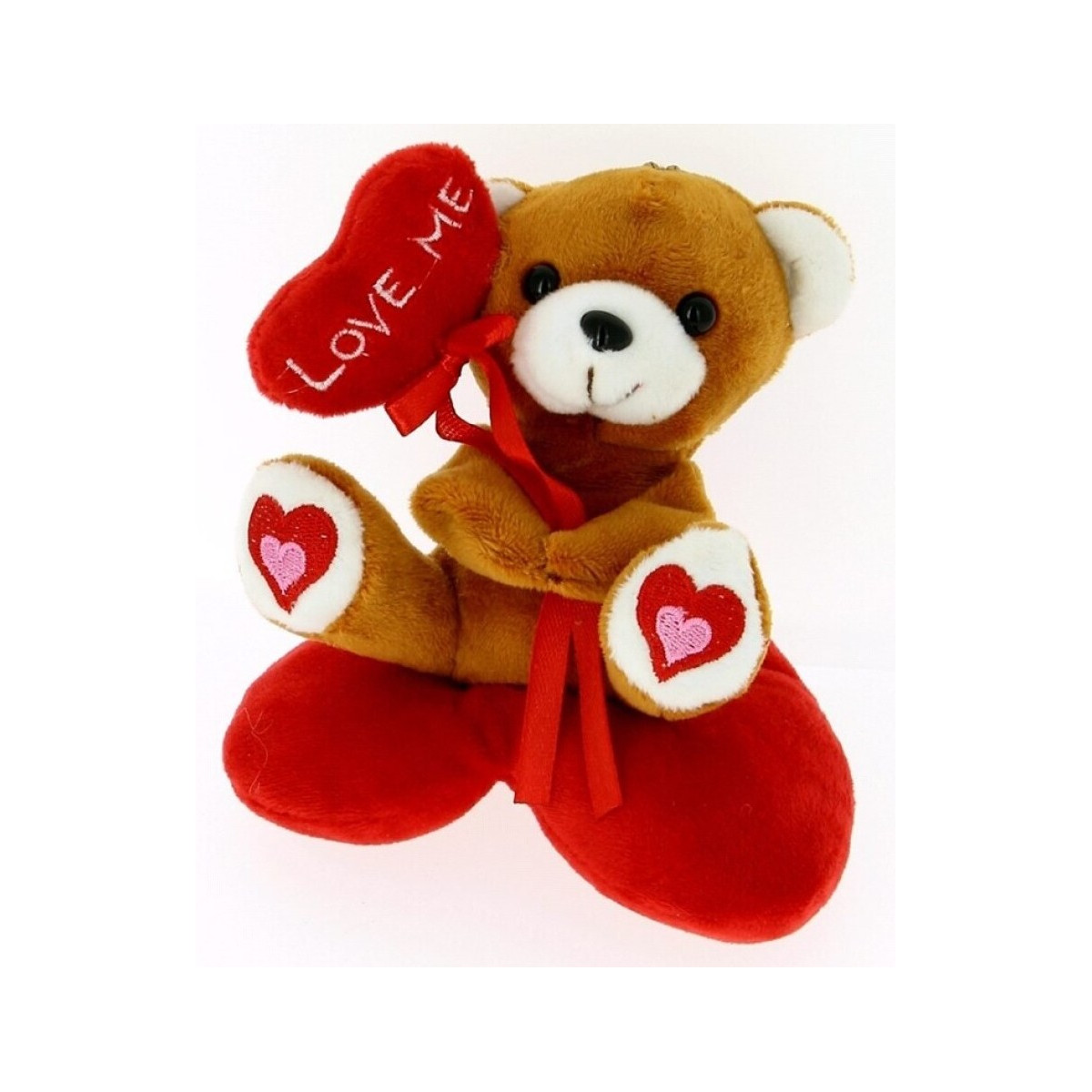 Peluche orsetto su cuscino a forma di cuore