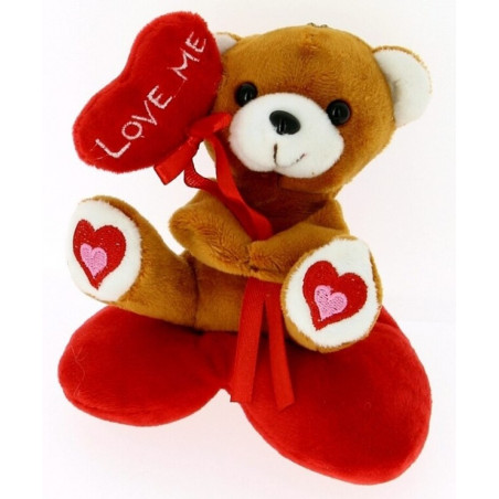 Peluche orsetto su cuscino a forma di cuore